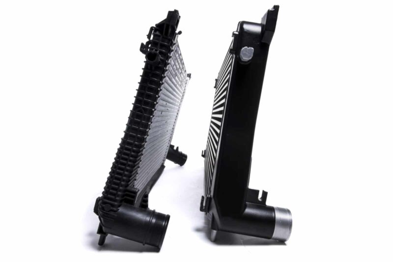 Racingline-MQB-Intercooler-1-1jpg - OPSHOLDERS Two black automotive radiators standing upright and leaning toward each other on a white background