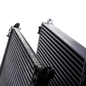 Racingline-MQB-Intercooler-8-1jpg - OPSHOLDERS Two large finned metal heat sinks arranged in a V, for cooling components.