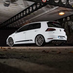 Racingline_Lowering_Springs_MK7R_3jpg - OPSHOLDERS White Volkswagen Golf R hatchback parked under an industrial overhead structure, viewed from the side/rear.
