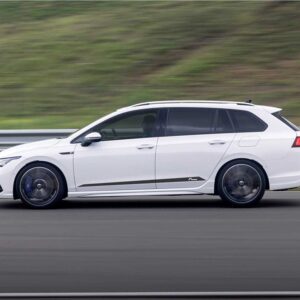 Racingline_Springs_MK8R-Estatejpg - OPSHOLDERS White station wagon in motion on a highway, blurred green landscape in the background, showcasing a side profile with dark windows and blue brake calipers visible through the wheels.