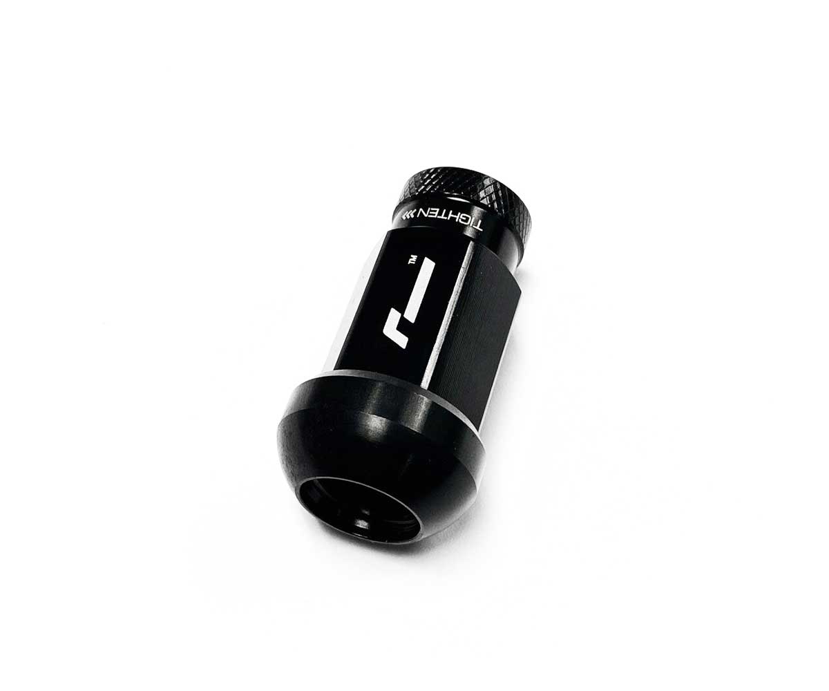 Untitled-1-14jpg - OPSHOLDERS Close-up of a small black cylindrical tool with a knurled cap and white label on a white background.