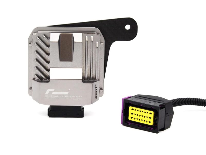 Automotive engine control unit (ECU) with a metal housing and a black mounting bracket beside a yellow multi-pin connector on a cable.