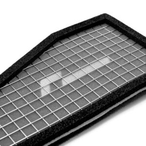 Close-up of a rectangular air filter with a metal grid and black foam frame.