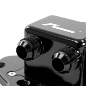 Close-up of a glossy black optical device with two protruding tubes, likely part of a microscope or camera accessory.