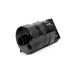 Black camera lens with knurled grip lying on its side against a white background, close-up view by the front element and mount area.