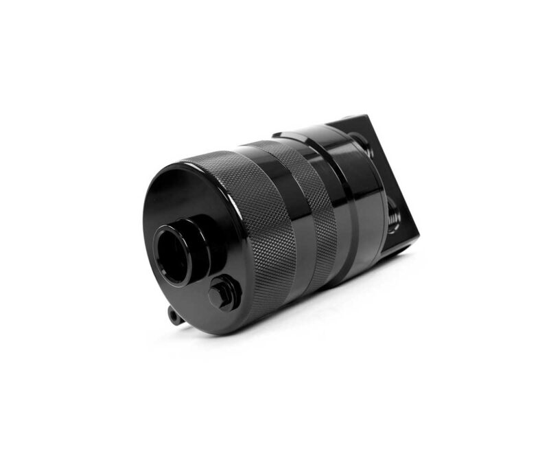 Black camera lens with knurled grip lying on its side against a white background, close-up view by the front element and mount area.