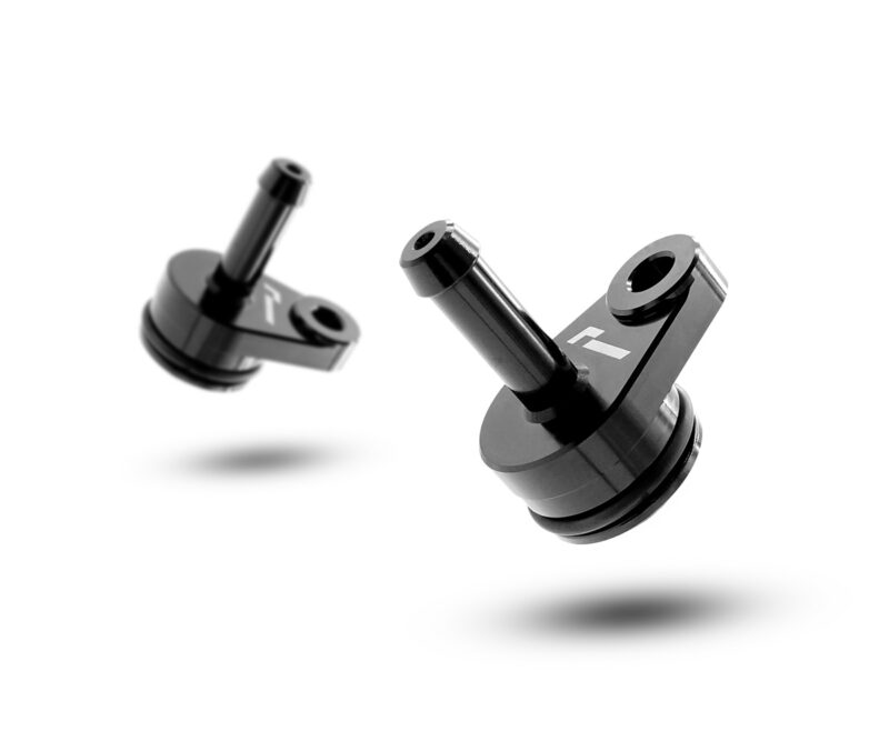 VWR140014jpg - OPSHOLDERS Two black metal precision parts with cylindrical shafts and circular bases, floating over a white background with soft shadows.