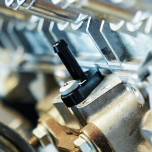 VWR140014_8-1jpg - OPSHOLDERS Close-up of a metal mechanical assembly featuring a black adjustment knob and surrounding brackets and bolts.