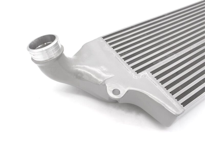 VWR143000_5-1jpg - OPSHOLDERS Aluminum intercooler core with curved pipe fitting and fins, close-up view.