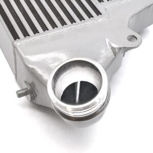 VWR143000_6-1jpg - OPSHOLDERS Close-up of a silver automotive intercooler with a circular inlet/outlet port and mounting flange, used to cool turbocharged air