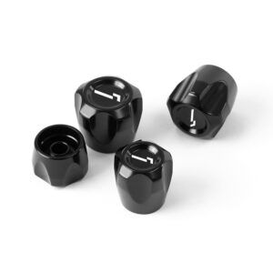 Four black glossy metal knobs with white indicators arranged on a white surface.