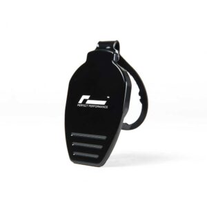 Black handheld fitness device with a strap, featuring the logo 'Perfect Performance' on its curved front and three silver slits at the bottom.