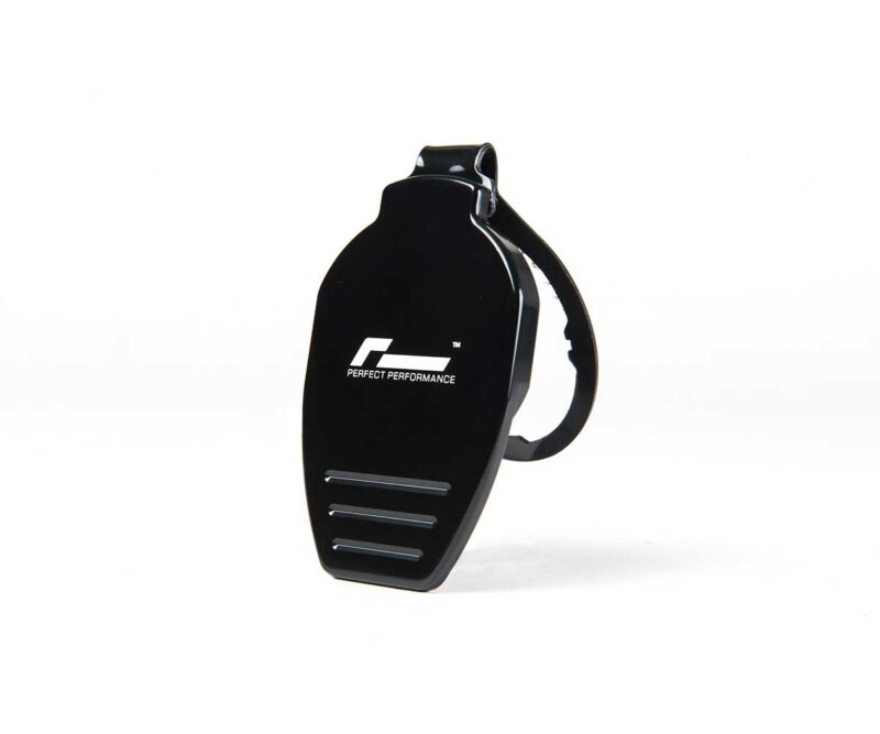 Black handheld fitness device with a strap, featuring the logo 'Perfect Performance' on its curved front and three silver slits at the bottom.