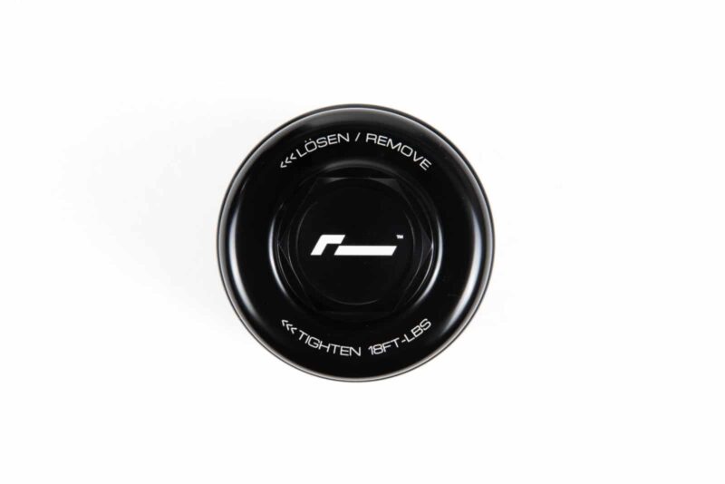 Black circular dial with a white center logo and edge text reading “LÖSEN / REMOVE” and “TIGHTEN 18FT-LBS” on a white background.