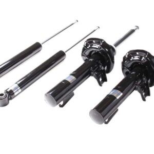 Set of black automotive shock absorbers laid out on a white background.