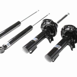 Set of black car shock absorbers and struts laid out on a white background
