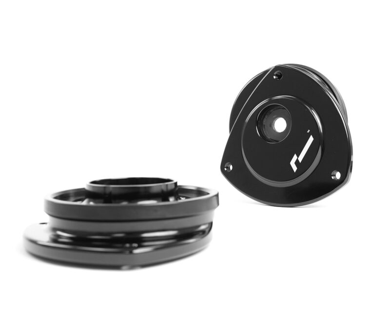 VWR430000_7jpg - OPSHOLDERS Two black glossy metal rings or adapters with a central hole, shown against a white background; one piece sits upright revealing screw holes.