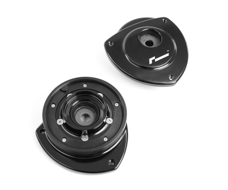 VWR430000_9jpg - OPSHOLDERS Disassembled automotive suspension component: two black circular mounts with central holes and mounting screws, shown at an angle on white background