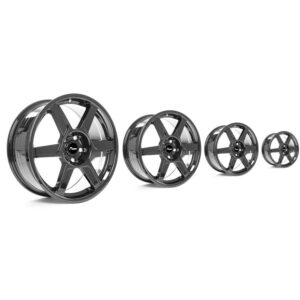 Set of shiny alloy car wheels in varying sizes arranged from largest to smallest.