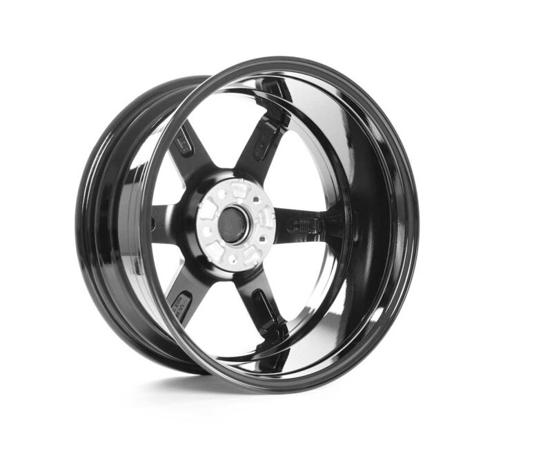 Black five-spoke alloy wheel rim with a polished lip, photographed at an angle to show depth and center hub.