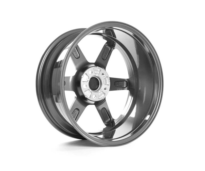 VWR610401_1jpg - OPSHOLDERS Shiny chrome alloy car wheel rim with five spokes, viewed at an angle showing the hub and lug nut holes
