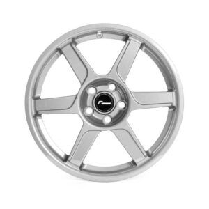 Silver five-spoke alloy wheel with a black center cap and visible lug nut holes around it.