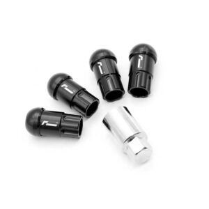 Five black bicycle valve cores with a silver adapter on a white background; arranged in a circular pattern, used to seal or adapt valve stems.