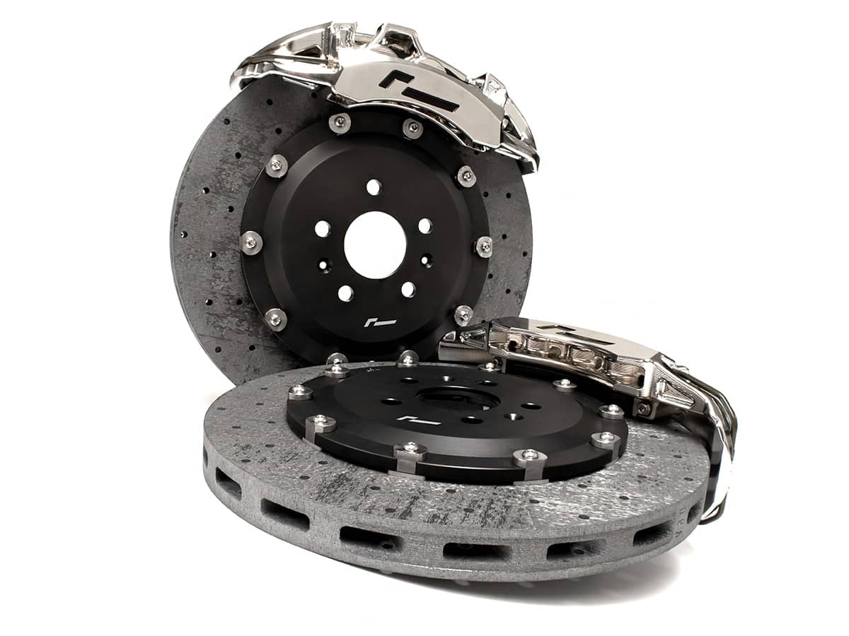 VWR651000-1jpg - OPSHOLDERS Pair of high-performance brake rotors with a silver caliper resting on top, shown against a white background.