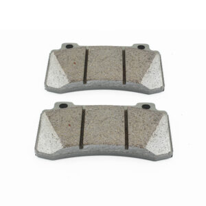 Two curved automotive brake pads on a white background, arranged parallelly.