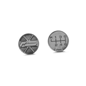 Two silver coins on a white background; left coin has a geometric logo, right coin shows a car gearshift diagram with R and numbers 1–6.