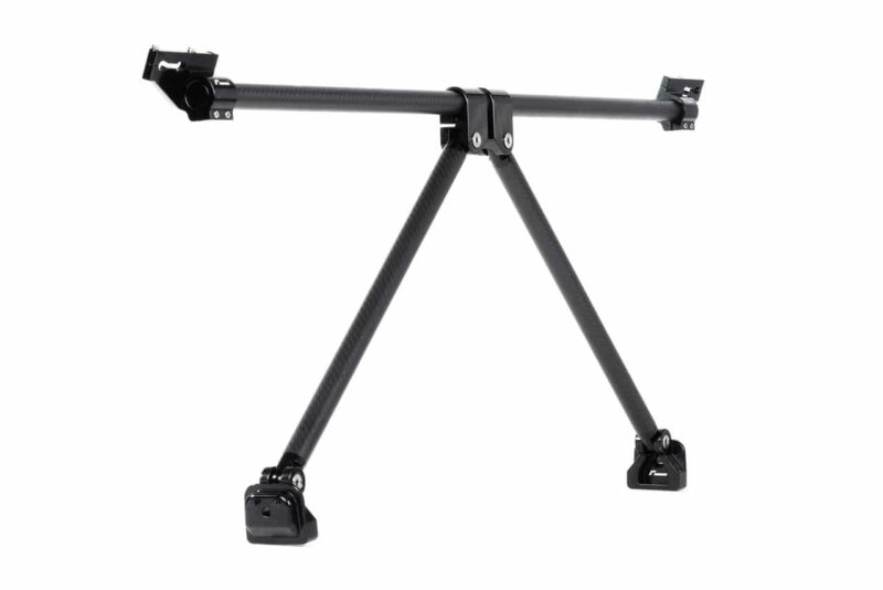 VWR81G700_2-1jpg - OPSHOLDERS Carbon fiber camera rig with a horizontal rail supported by a triangular tripod base (three legs). The image shows a three-legged camera support stand.