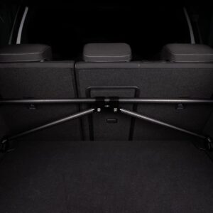 VWR81G700_3-1jpg - OPSHOLDERS Carbon-fiber crossbar bike rack installed across the rear cargo area behind the back seats of a vehicle, securing items in the trunk.