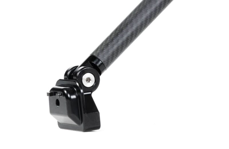 VWR81G700_5-1jpg - OPSHOLDERS Close-up of a carbon-fiber pole ending in a black GoPro-style action camera mount; ready to attach a camera.