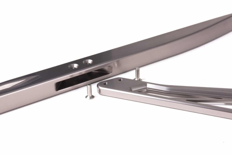 audi-b9-a4s4-strut-brace_28703497378_o-1jpg - OPSHOLDERS Close-up of a silver metal drawer slide with mounting holes and a detached bracket with two screws nearby.