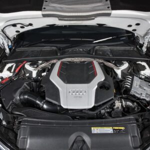 audi-b9-a4s4-strut-brace_28703771618_o-1jpg - OPSHOLDERS Open hood reveals a modern Audi V6 engine with silver and red accents in a clean engine bay, front view in white car.