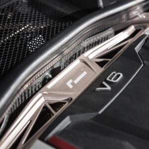 audi-b9-a4s4-strut-brace_28703794348_o-1jpg - OPSHOLDERS Close-up of a car engine bay with a prominent V8 badge and metallic trim near a vented grille.