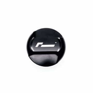 Black glossy circular object with a white geometric logo on a white background, photographed from slightly below.