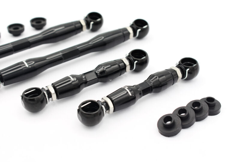 audi-c8-adjustable-height-suspension-links_53337742493_o-1jpg - OPSHOLDERS Black rod-end joints with ball sockets and threaded shafts, arranged with several small black spacers on a white background.