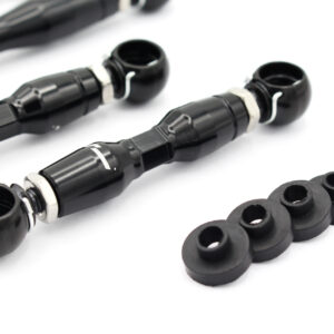 audi-c8-adjustable-height-suspension-links_53337851214_o-1jpg - OPSHOLDERS Pair of black bicycle bar-end shifters with metal clamps and white retention rings, plus rubber washers on a white surface.