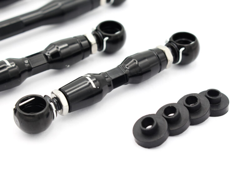 audi-c8-adjustable-height-suspension-links_53337851214_o-1jpg - OPSHOLDERS Pair of black bicycle bar-end shifters with metal clamps and white retention rings, plus rubber washers on a white surface.