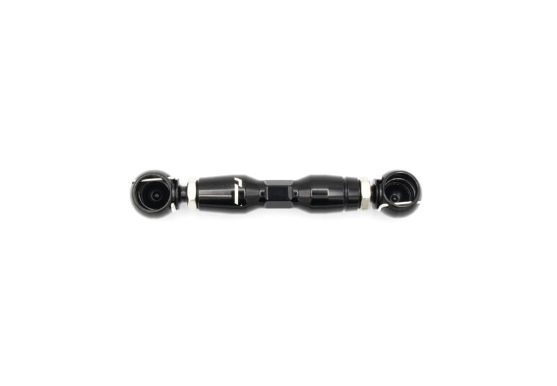 audi-c8-adjustable-height-suspension-links_53337974615_o-scaled-1jpg - OPSHOLDERS Black bicycle stem laid horizontally on a white background, showing clamp bolts on both ends and a machined central body with a glossy finish.