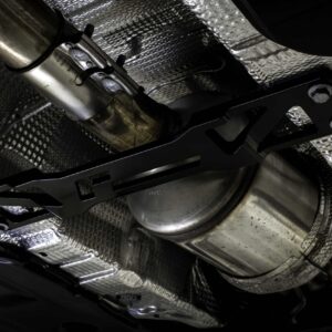 Underbelly of a vehicle showing the exhaust pipe and heat shielding from below.