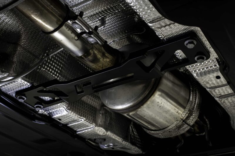 Underbelly of a vehicle showing the exhaust pipe and heat shielding from below.