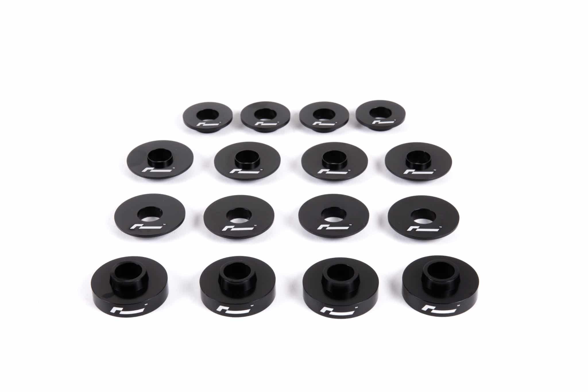 dead-set-1_30930710387_o-scaled-2jpg - OPSHOLDERS Row of black circular washers with a central hole and white logo, arranged on a white surface in a grid pattern.