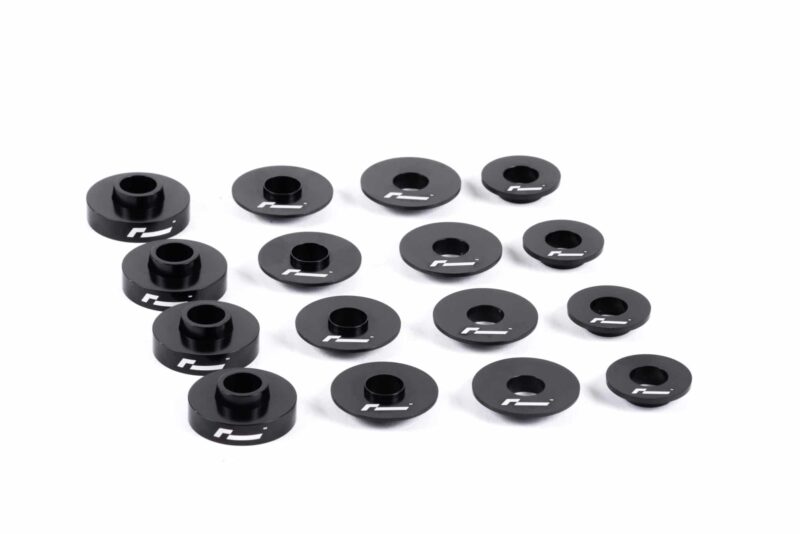 dead-set-5_30930705827_o-scaled-2jpg - OPSHOLDERS Set of black circular spacers with central holes and white logo, scattered on a white background.