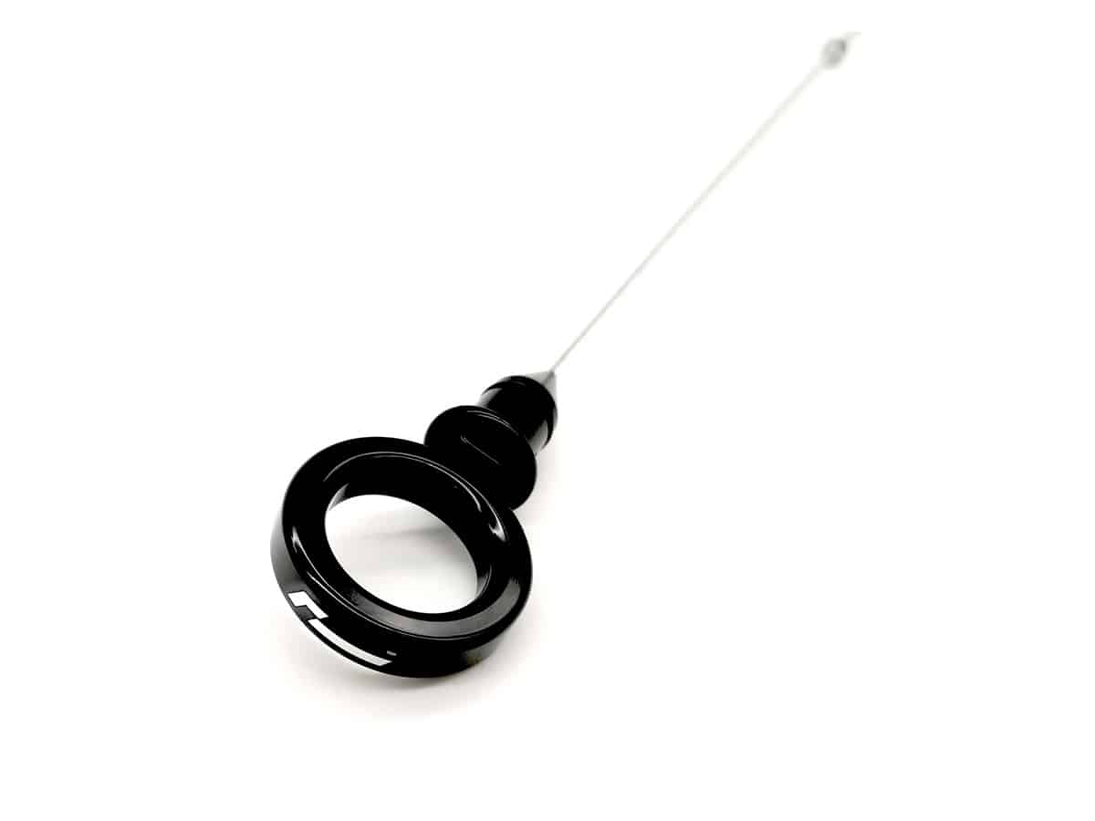 dipstick_1jpg - OPSHOLDERS Black circular ring-like instrument with a long slender rod extending away from it.