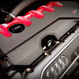 dipstick_5jpg - OPSHOLDERS Close-up of an Audi engine cover with red intake fins and the TFSI badge, four-ring logo visible.