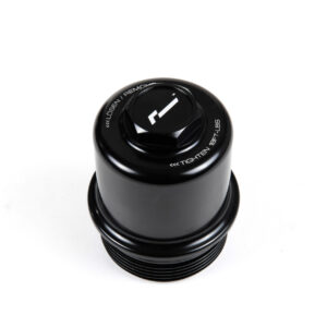 dsg-oil-filter-housing-dq250_45869756811_o-scaled-1jpg - OPSHOLDERS Close-up of a black camera lens or cap from above, with white text around the rim and a central knob/marking.