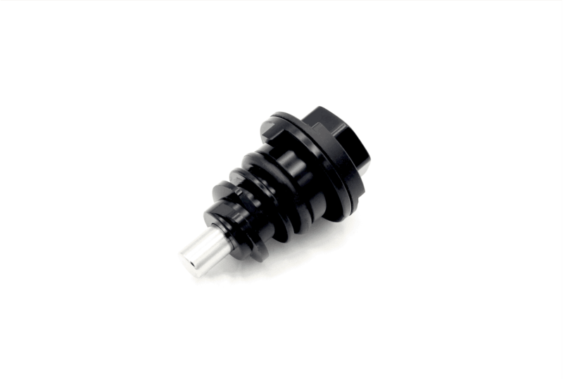 Close-up of a black, ridged mechanical component with a metal shaft, set against a white background