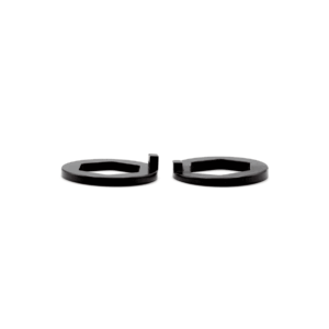 Two black circular spacers with rectangular cutouts, placed side by side on a white background